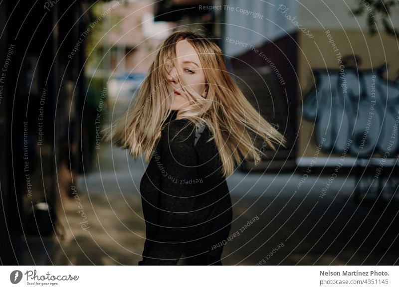 Portrait of a beautiful blonde caucasian woman moving her hair portrait urban style confident lifestyle attractive young Style girl Caucasian Fashion people