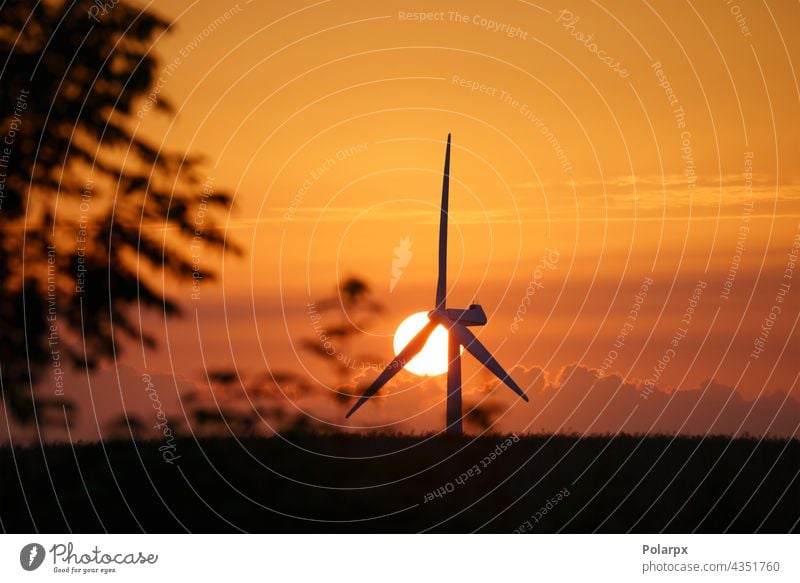 Windmill in a sunset in a rural summer landscape station farm efficiency field rotors green propeller blue mountain park natural clean wind turbines sunlight