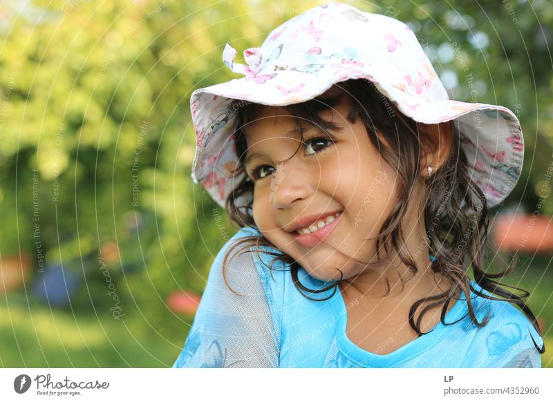 girl smiling at the camera wearing a hat To enjoy Optimism Religion and faith Connection Positive Innocent Playful showing Background picture happiness