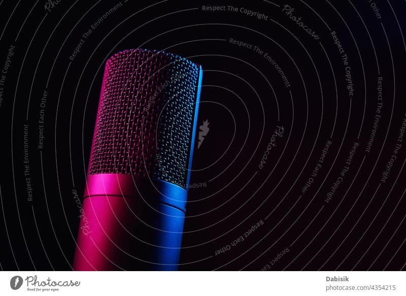 Studio microphone on dark background with neon lights audio podcast record interview speaker journalism concept radio recording studio broadcast broadcasting