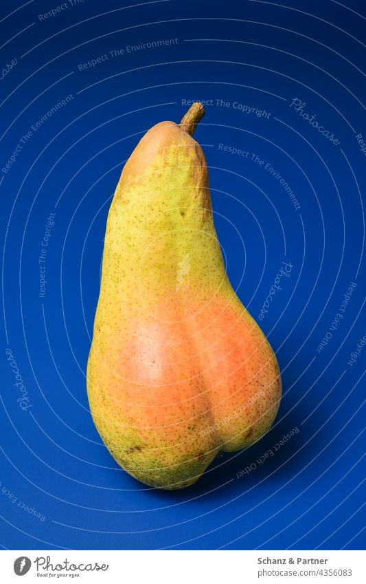 Pear with butt sunburn fruit Fruit Sunburn buttocks Red Yellow Blue Blue background Isolated Image exempt plain background Food Nutrition Healthy