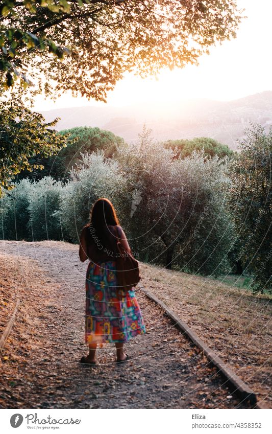 Back view of woman with colorful skirt in nature with evening back light Woman Nature Back-light Evening sun evening light Sunlight Skirt variegated
