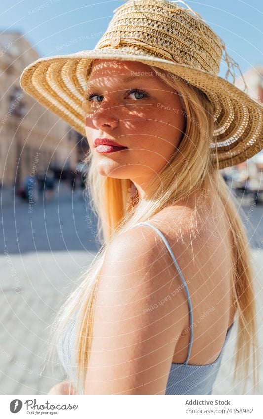 Woman in straw hat on sunny day in city - a Royalty Free Stock ...