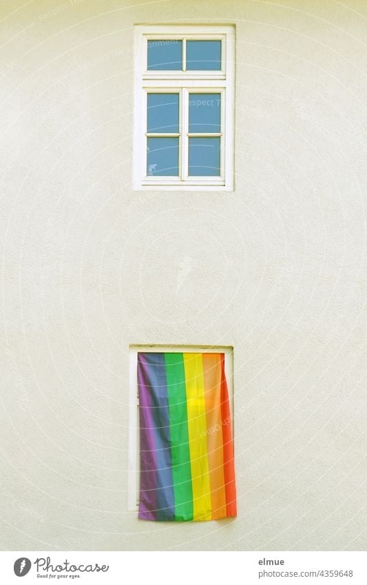 One of the two windows of the apartment building is covered with a rainbow flag / symbol of the lesbian and gay movement / tolerance Rainbow Window