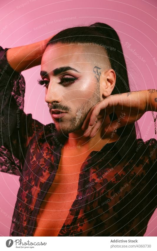 Stylish transgender woman posing at studio portrait transvestite lgbt male glamorous bearded fashion transsexual make-up lgbtq closed eyes person feminine young