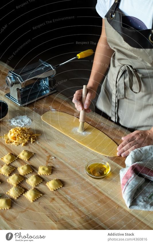 Anonymous Person Preparing Homemade Raviolis chef food preparation cooking table wooden flour board dough closeup cooked cuisine culinary culture dish dumpling