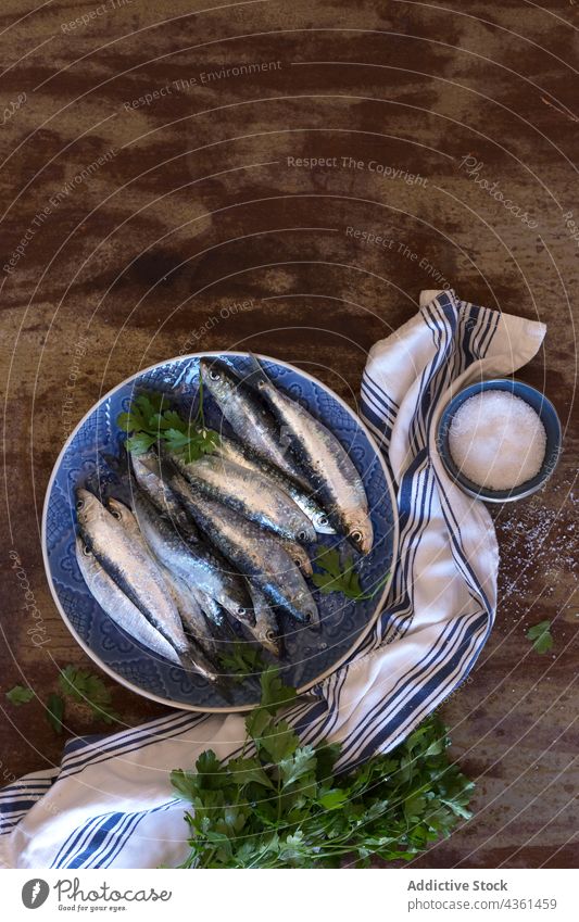 Top view of a plate with fresh sardines fish seafood freshness animal healthy mediterranean raw diet marine market nutrition preparation industry ingredient