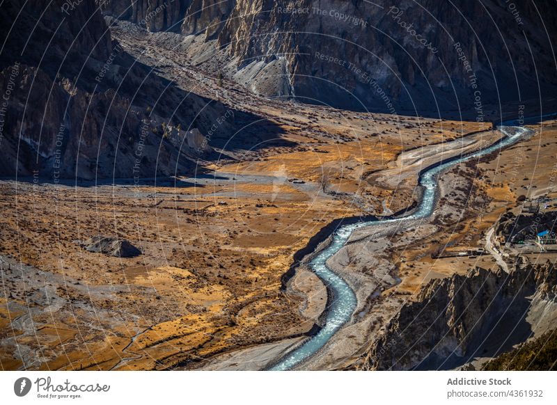 Winding river flowing through mountainous valley landscape highland stream scenery picturesque amazing himalayas nepal nature water scenic terrain rock