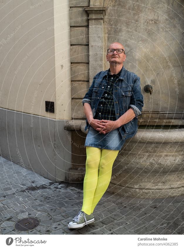 https://www.photocase.com/photos/4362385-man-in-jeans-mini-and-yellow-pantyhose-sits-on-a-fountain-and-looks-satisfied-photocase-stock-photo-large.jpeg
