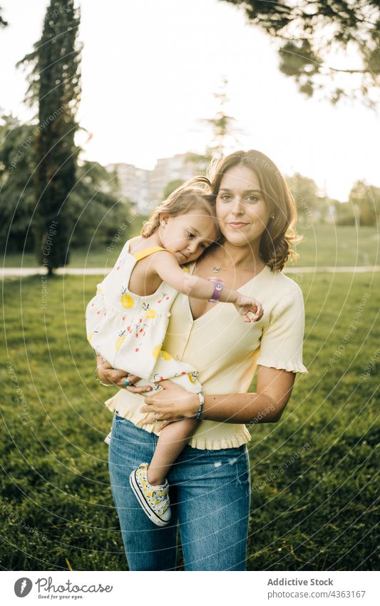 Young woman with toddler daughter in park mother together summer love kid happy cute child mom relationship little bonding lifestyle fondness affection tender