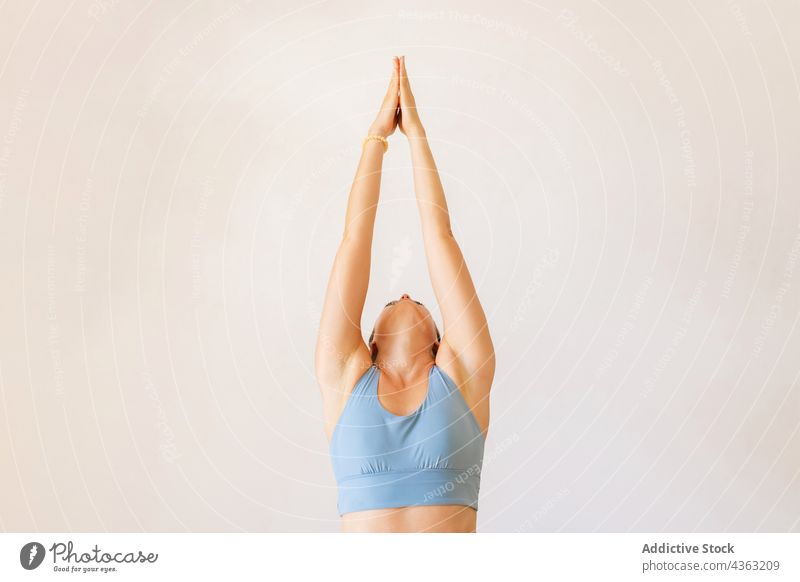 Girl releasing stress calming down before important meeting, meditating  with closed eyes in lotus pose with raised hands orbs zen gesture,  practicing Stock Photo - Alamy