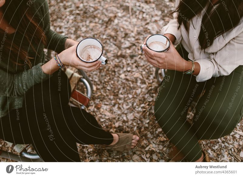 overhead shot of women holding thier hot chocolate in camping chairs 18-25 20-25 autumn blue cell phone cheers community cook cookware culinary