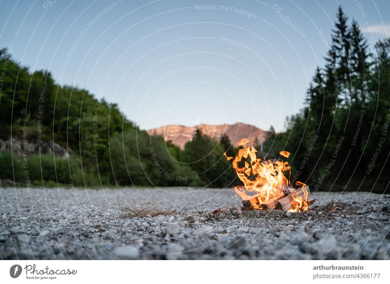 Campfire in the stony riverbed in the nature near the mountains Nature Forest Experiencing nature Love of nature woodland Edge of the forest