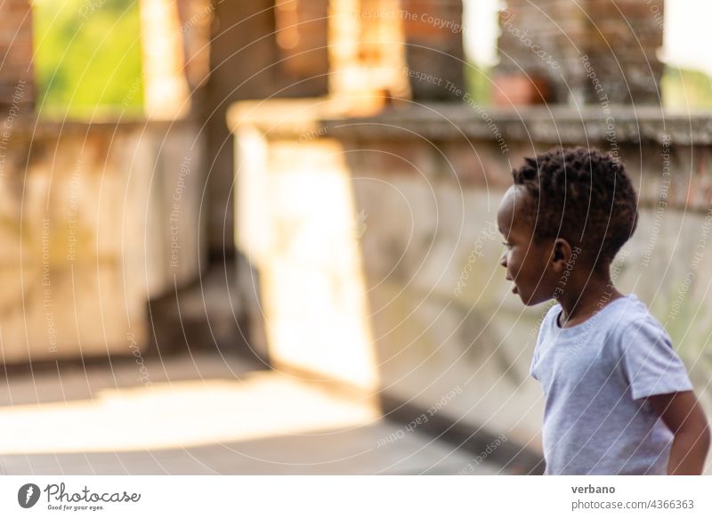 african boy playing in the patio child kid little childhood young fun people person happy game activity summer park sport football soccer afro home happiness