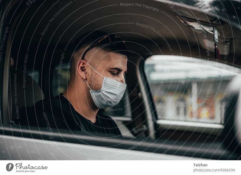 Portrait of driver wearing protective medical mask coronavirus driving epidemic illness passenger protection quarantine traffic transportation person taxi man
