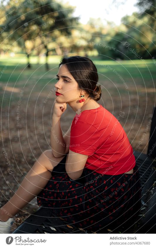 Peaceful woman sitting on bench in summer park weekend chill charming enjoy carefree peaceful female tranquil serene lean on hand content calm pleasure harmony