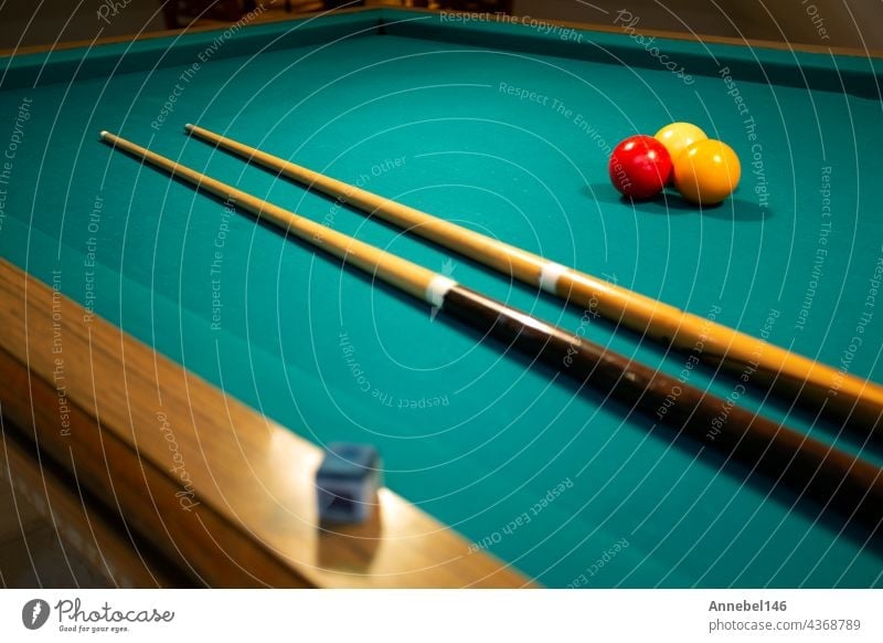 A green cloth billiards or pool table red,yellow and white ball,hobby and sport with copy space game leisure cue play snooker entertainment competition fun