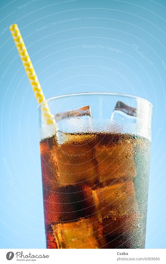 https://www.photocase.com/photos/4369666-a-glass-of-cola-with-ice-on-blue-and-pink-background-photocase-stock-photo-large.jpeg