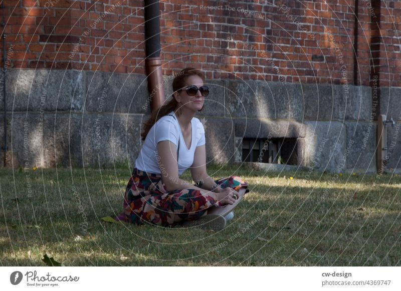 woman sitting in front of a church Woman Church yard Sit Exterior shot Colour photo