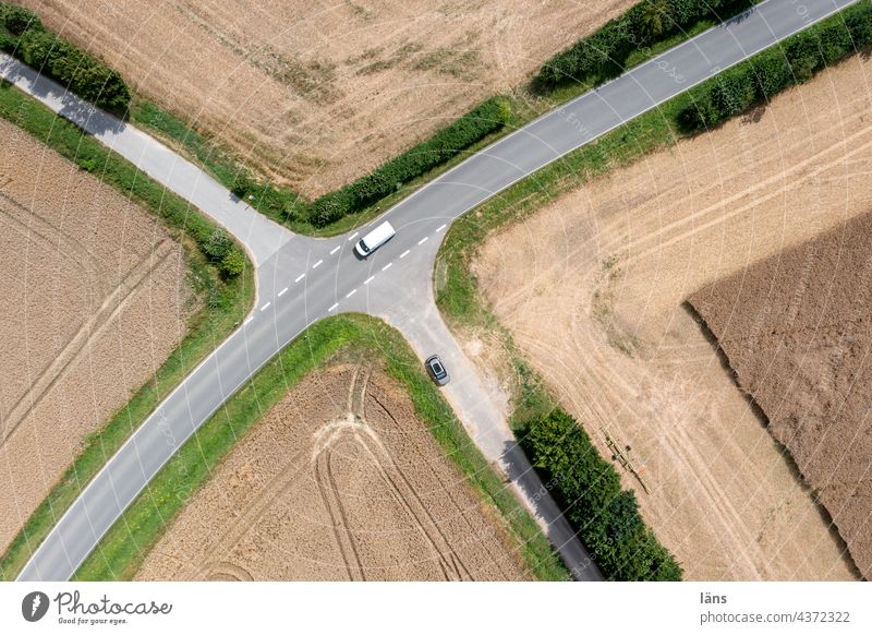 Street crossing from above Lanes & trails Field Traffic infrastructure Bird's-eye view Landscape Colour photo Lines and shapes Road traffic Aerial photograph