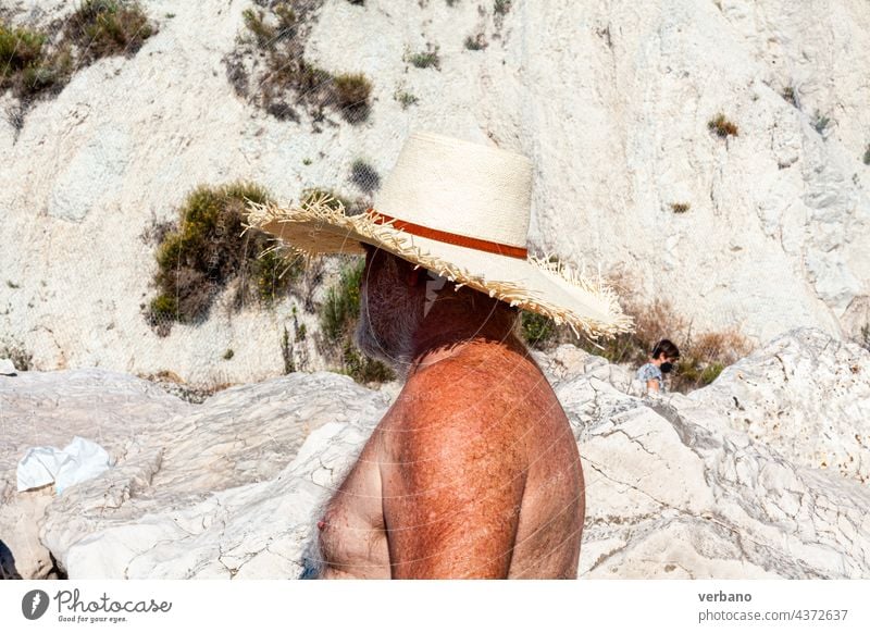 senior man in the beach with hat, nude torso vacation happy sea retirement holiday caucasian retired people sand leisure lifestyle summer ocean mature old