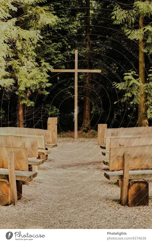Devotional place with wooden benches and wooden cross. Place of worship devotion Vestry Bench Wooden bench Wooden cross Crucifix trees Woodground Gravel gravel