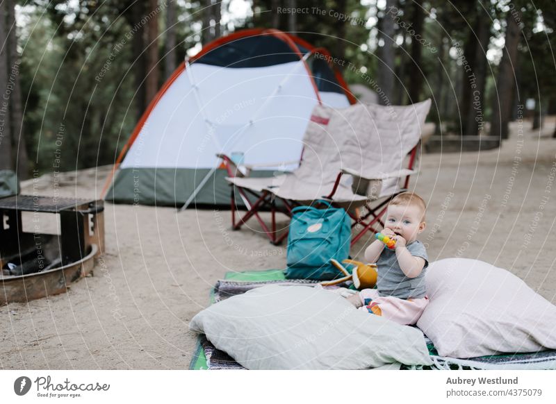 baby playing on the ground at a tent campsite 6 months california camper camping chair chewing child childhood daughter eating family fire forest fun girl happy