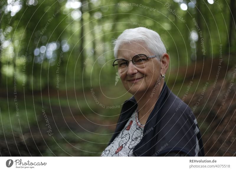 Portrait - senior woman smiling in forest portrait Woman Grandmother Female senior 60 years and older White-haired Gray-haired naturally Authentic Eyeglasses