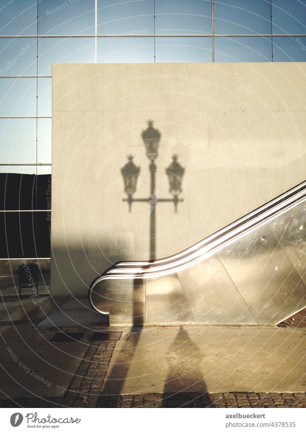 Shadow of an old street lamp on a modern facade streetlamp Street lighting Old New Old fashioned Modern Modern architecture Architecture Facade Building