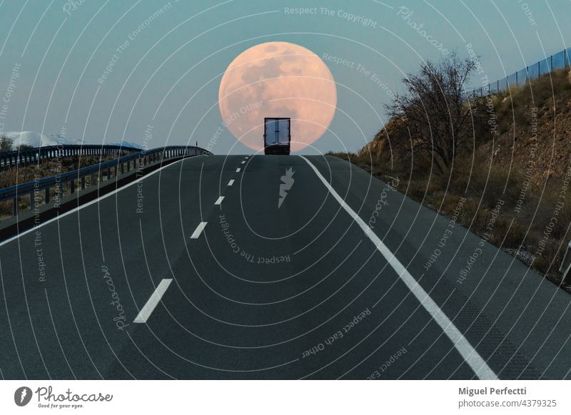 Refrigerated truck on a highway, at the top of a slope with the full moon in the background. road refrigerated truck horizon travel transport delivery nature