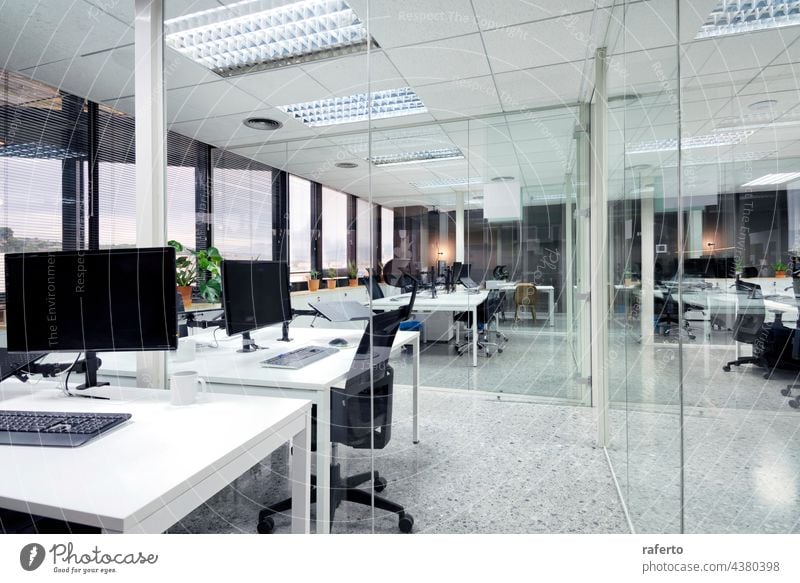 modern open space office with computer monitors on white desks nobody business interior room indoor design table empty work workplace chair furniture style