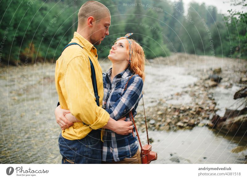 Playful happy handsome couple having while walking in woods. tourists in the mountains. Adventure in nature concept. active relationship love playful piggyback