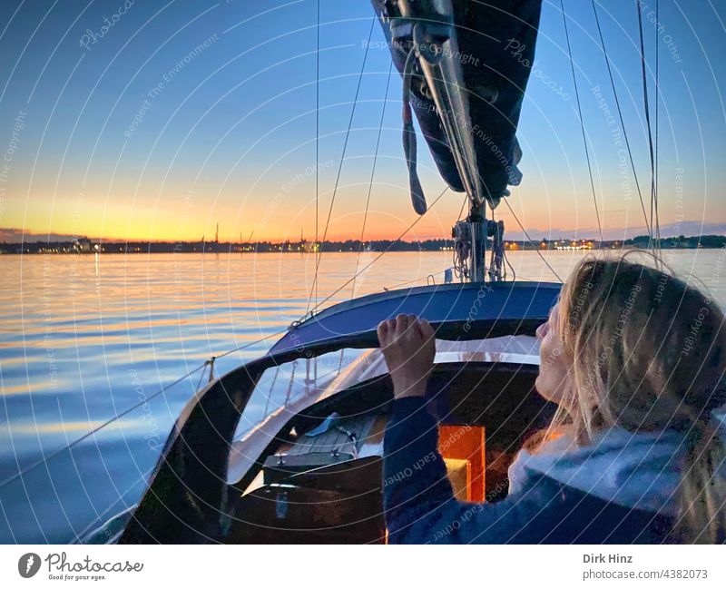 Woman on a yacht looking towards the evening sky on the Kiel Fjord Sailboat Sailing Baltic Sea Ocean Water Exterior shot Vacation & Travel Freedom Yacht