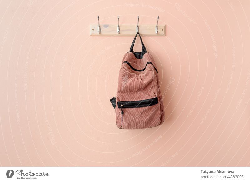 Pink backpack on hook hanger bag wall hanging school canvas clothes carry fabric interior material object space nobody indoor pink rack student textile