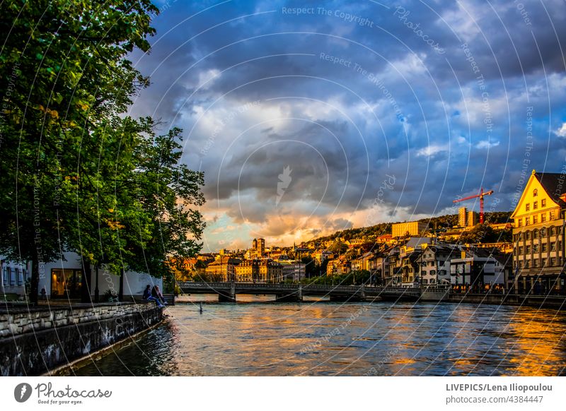 Cloudy sky in the sunset over the Limmat Zurich architecture atmosphere blue buildings central Europe church city city-center city-life clouds cloudy colorful