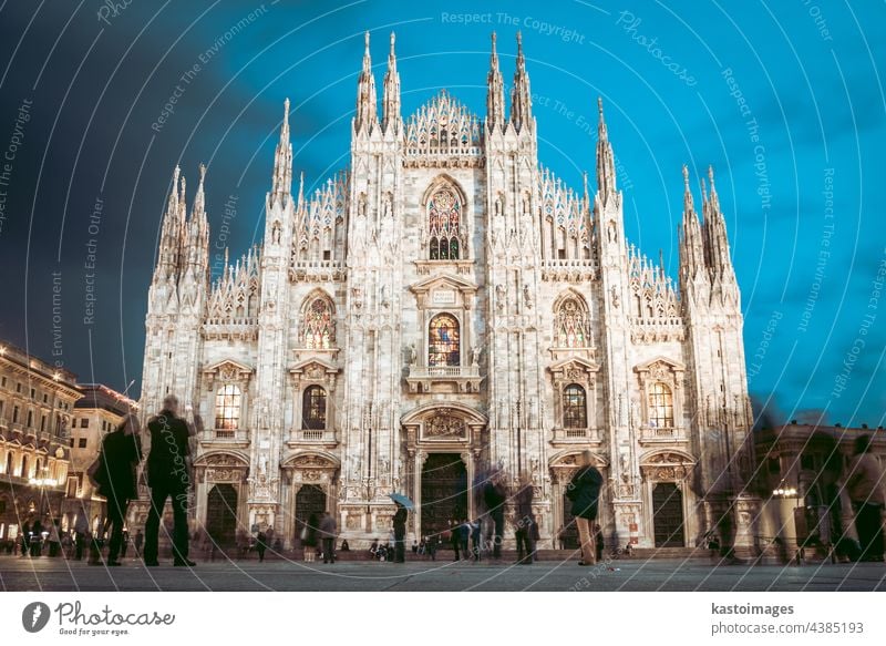 Milan Cathedral , Duomo di Milano, is the gothic cathedral church of Milan, Italy. Shot in the dusk from the square ful of people milan italy landmark duomo