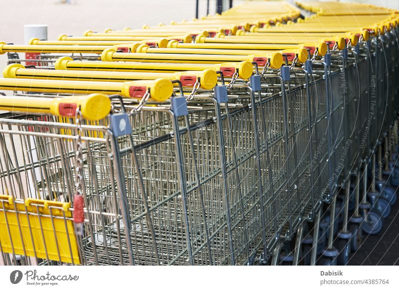 Row of empty shopping cart near a shop, close up supermarket basket retail store buy business background trolley grocery metal sale consumer purchase customer