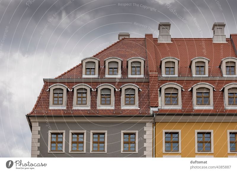 Colorful facade of an old building with skylights and tile attic Old building Attic story Roof House (Residential Structure) brick pediment Architecture