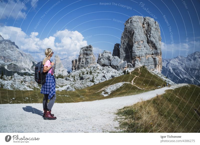 Hiker with backpack explore Cinque Torri mountains in Dolomites, Italy italy dolomites hiker cinque girl outdoor landscape travel sport hiking nature alps path