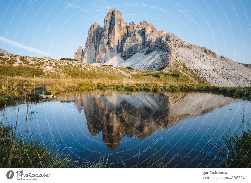 Famous Tre Cime di Lavaredo reflected in small pond, Dolomites Alps Mountains, Italy, Europe. Tre Cime mount in Dolomites dolomites tre cime alps mountains lake