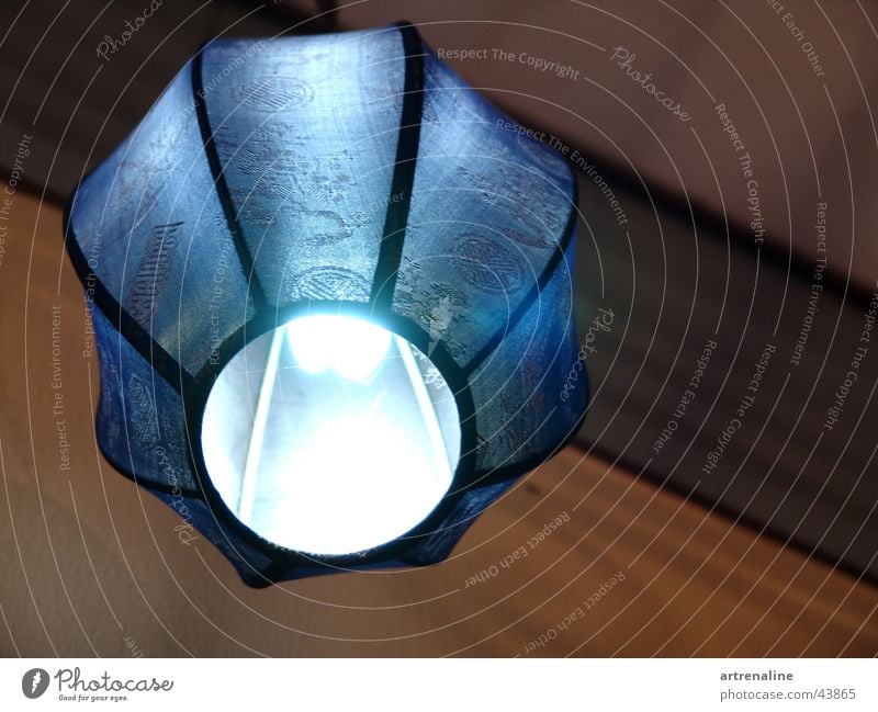 It glows blue. Lamp Light Wood Room Electric bulb Cloth Living or residing Umbrella panels