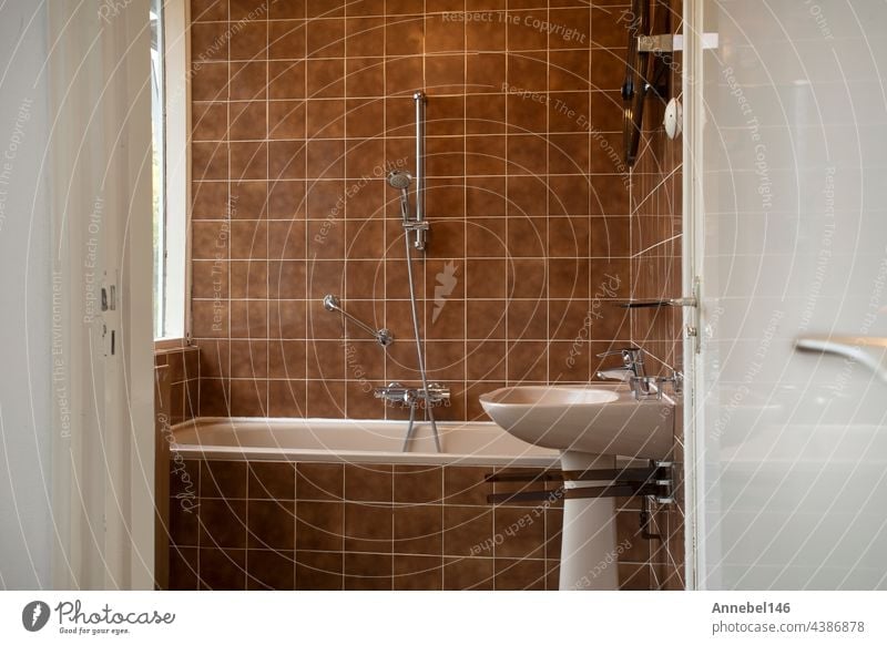 Architecture interior of a old vintage bathroom with brown tiles, Antique design, interior house concept hotel glass health indoors lamp light luxury mirror