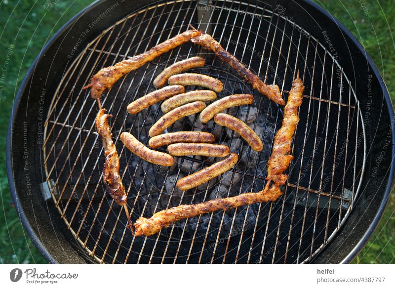 Barbecue with sausages and meat skewers artistically laid out on the kettle grill grill BBQ Bratwursts Meat Grating Barbecue (apparatus) Grill BBQ season