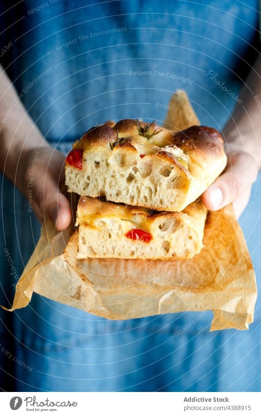 Hands holding focaccia slices baked tomato food homemade traditional italian rosemary portion fresh bread gourmet vegetable vegetarian dough hand meal lunch