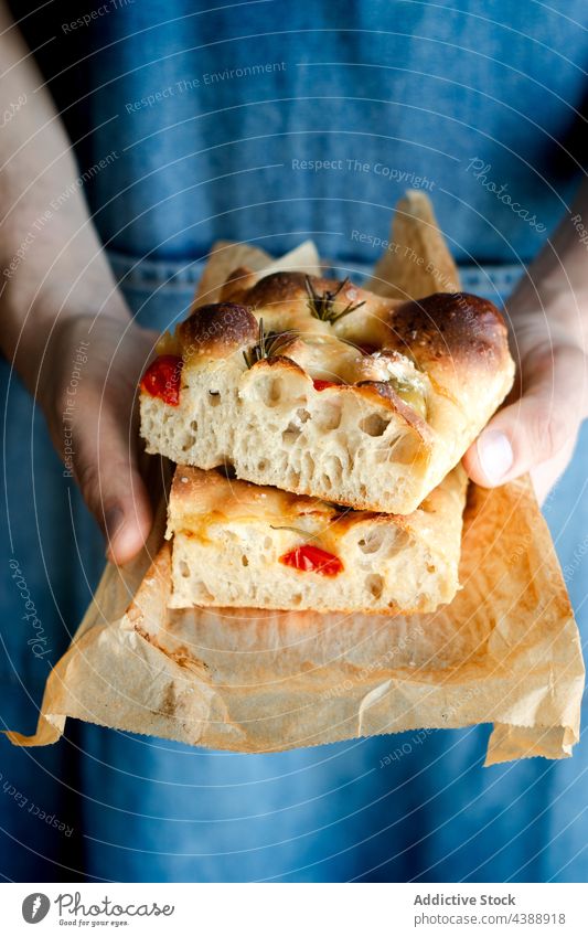 Hands holding focaccia slices baked tomato food homemade traditional italian rosemary portion fresh bread gourmet vegetable vegetarian dough hand meal lunch