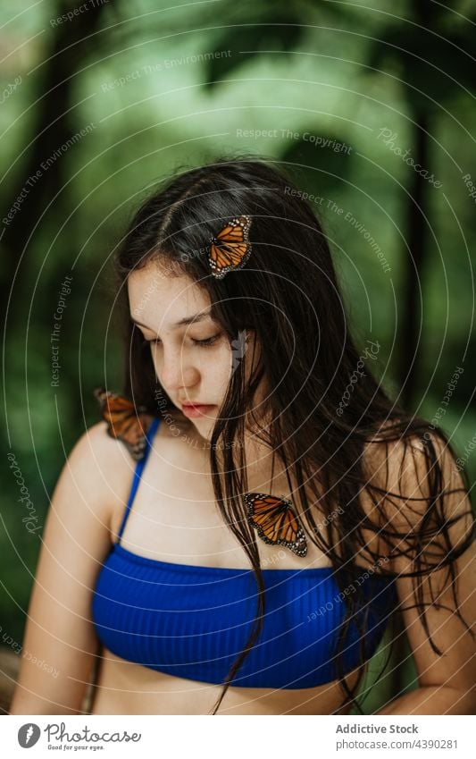Tender woman with butterflies in nature butterfly environment tender summer insect pure tropical colorful female young long hair traveler romantic recreation