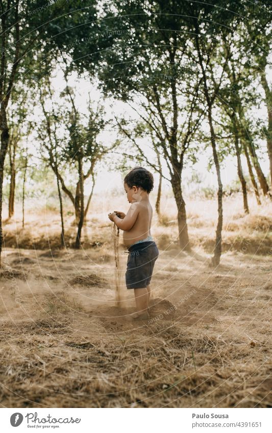 Child playing with soil childhood Playing Nature Summer Summer vacation Leisure and hobbies Childhood memory Lifestyle Day Joy Exterior shot Infancy