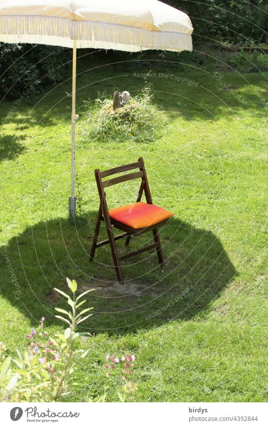 Single chair in the shade of a parasol on a lawn Chair Sunshade Sunlight Shadow shaded place Lawn Garden ardor Beautiful weather Grass Folding chair seat Summer