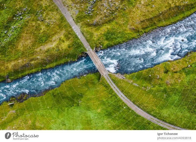 The aerial top down view of a milky blue river and a bridge, Iceland iceland remote rock scenery top view park tourism travel tree volcanic outdoor mountain