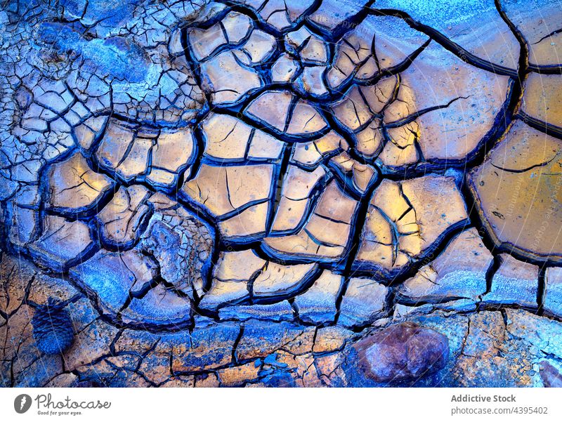 Abstract texture of cracked mud with wonderful colors and formations dryness background lifeless fractured parched earth dirty dirtied terrain hot crust lake
